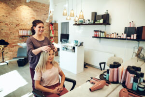 Young woman talking with her hairstylist during a salon appointment